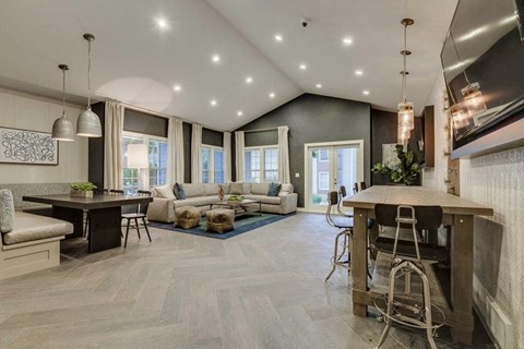 a living room with a kitchen and a table